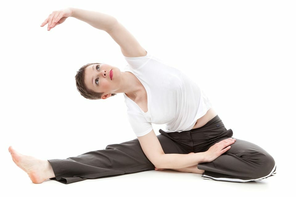 Lady streching her arm in the air in a yoga position