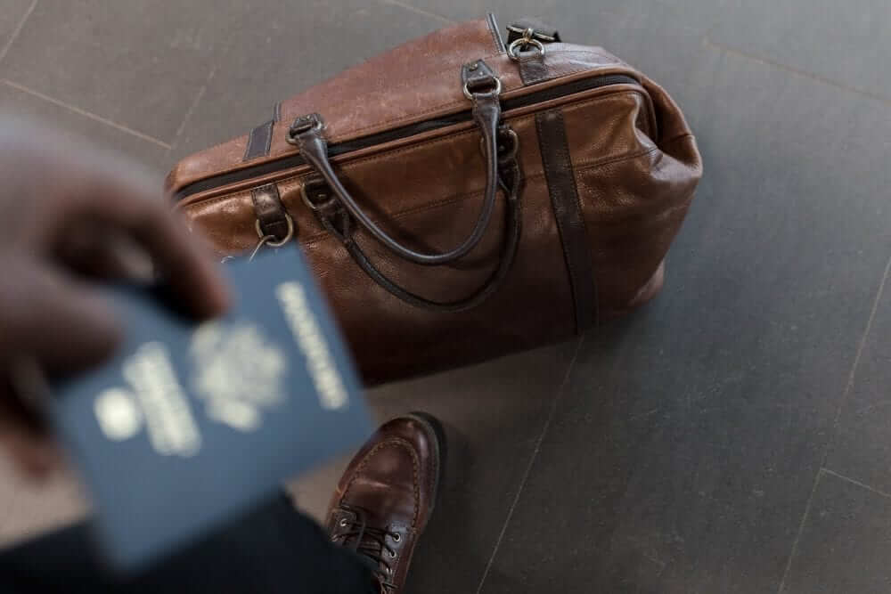 Brown carry on on the floor of the airport