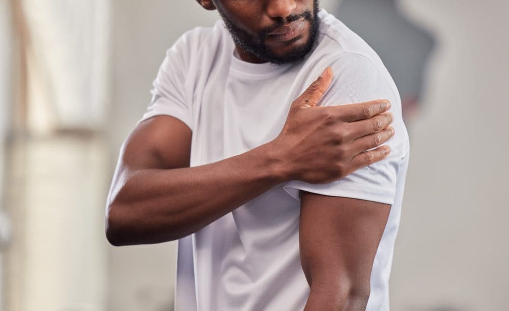 Man holding his shoulder in pain